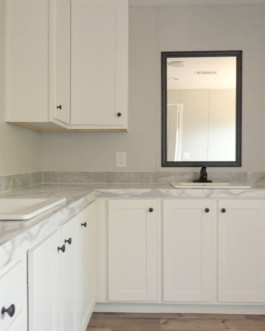 Tall vanity with a square porcelain sink and black faucet